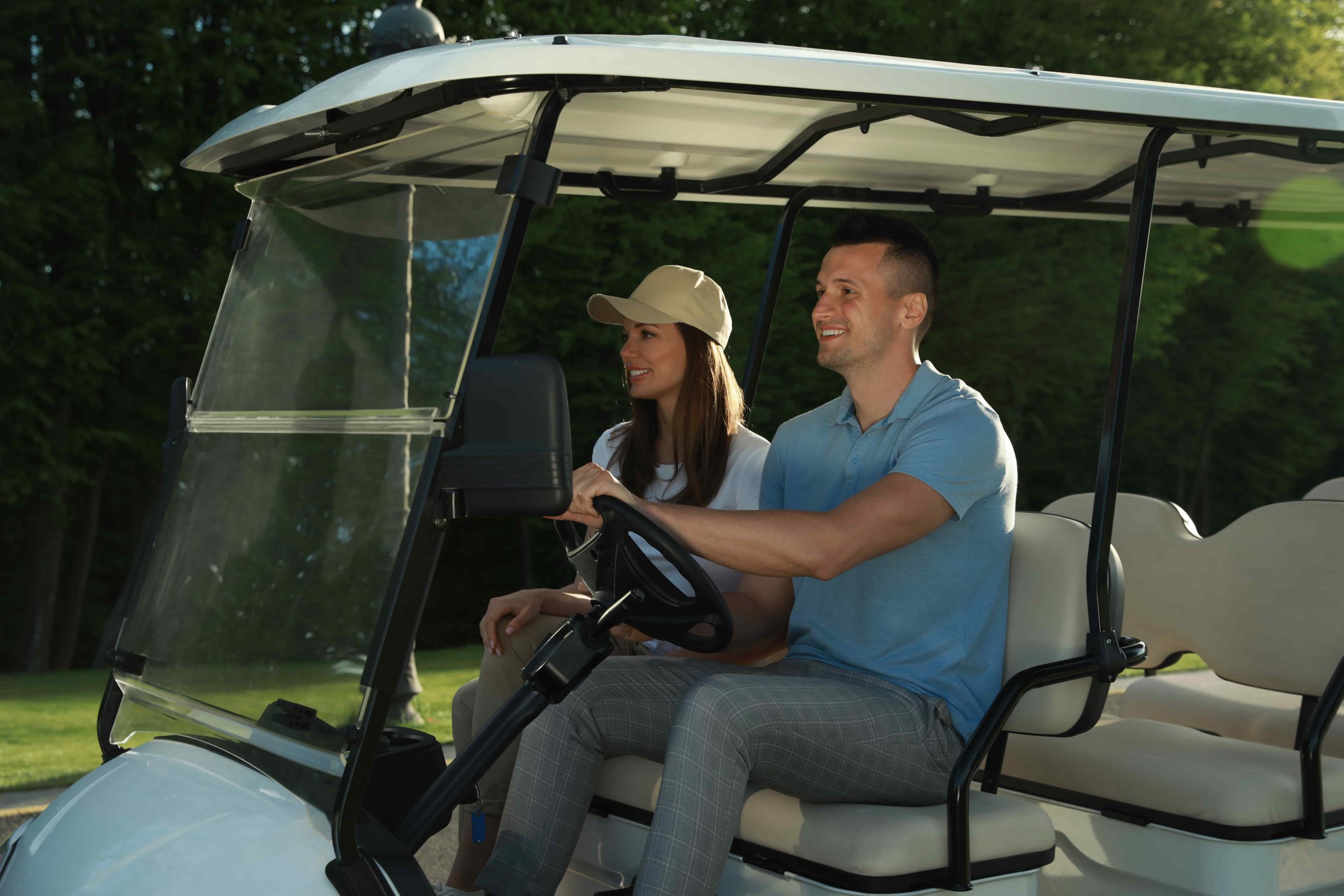 Happy couple driving a street legal golf cart